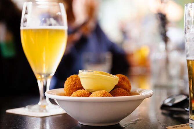 Amsterdam High-End Dutch Food & History Tour - Up to 8 guests - Tuesday through Friday balance cheese, fish, and old shops