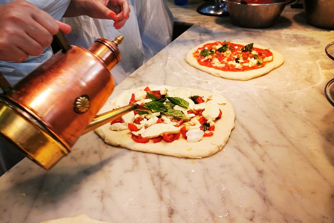 Authentic Pizza Making Class in Naples with Appetizers and Drink - Stretching your own pizza base