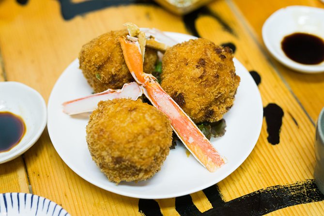 Best of Shinjuku: Izakaya Food Tour (4 Stops, 14+ Tastings) - Walking through Kabukicho after the first meal