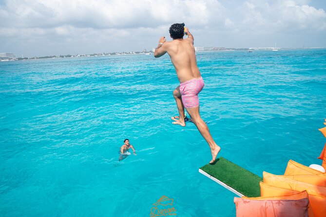 Dancer Cruise Isla Mujeres Snorkel Food and Drinks Included - Slide, trampoline, and a half-hour swim