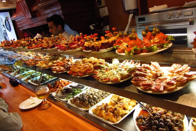 Night Tapas Walking Tour in Barcelona Modernist Area with Small Group and Dinner - Stop three: a local tapas bar with fish, meat, and vegetables