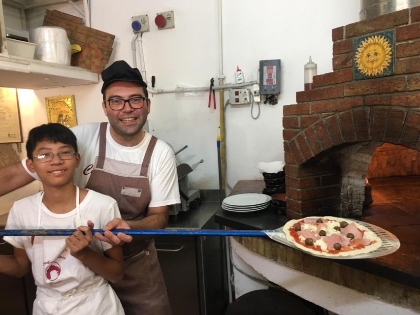 Taormina: Half-Day Pizza Making Class - Finishing the pizza in the working kitchen