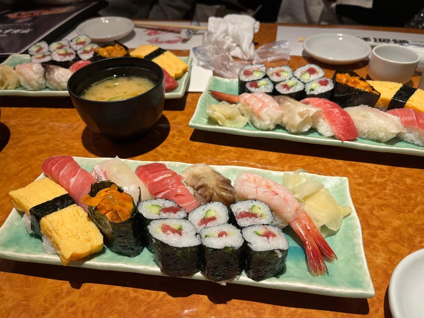 Tokyo: Wagyu and Sushi Gastronomic Journey - Kabukicho after dark, with Godzilla overhead