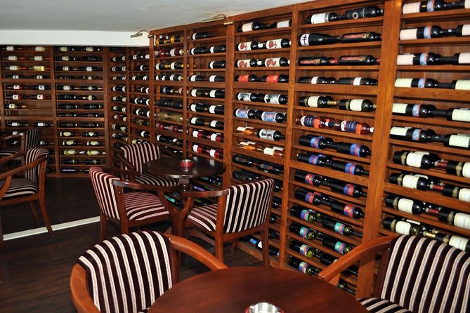 Traditions in Bucharest: Village Museum and Wine Tasting Tour - Romanian wine and a plate of local food